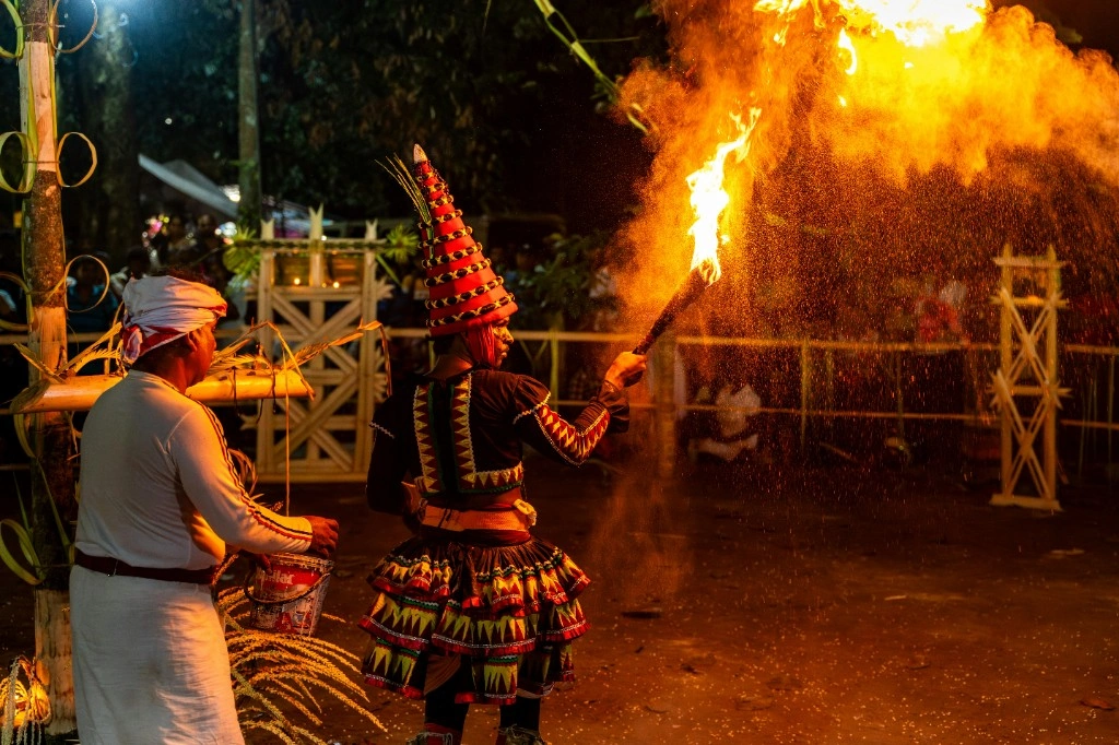 Traditional fire dance performance with flames at night in Sri Lanka