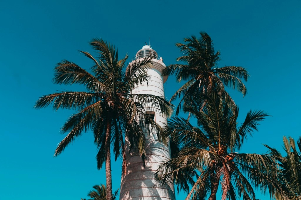 Historic lighthouse on the Sri Lankan coast under a bright sky