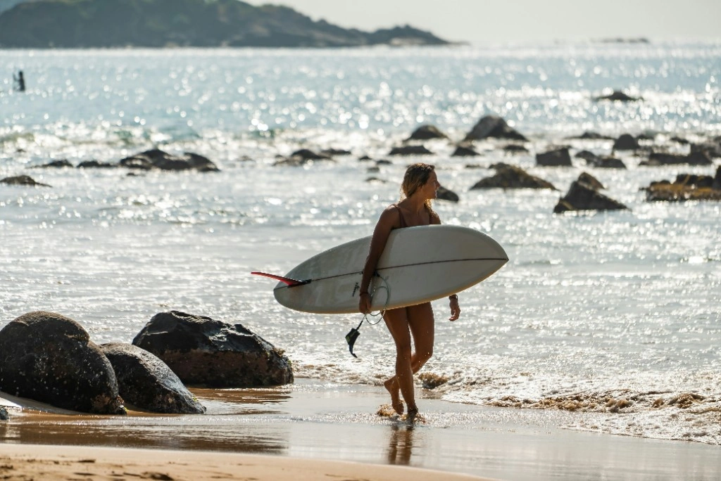 Surfer riding a wave on a tropical beach in Sri Lanka